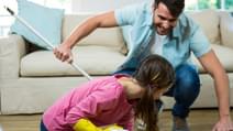 Daughter helping father to clean floor at home