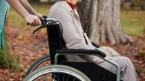 Disabled elder woman on wheelchair with nurse
