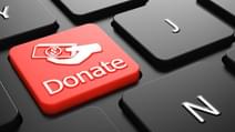 Donate with Money in the Hand Icon Red Button on Black Computer Keyboard