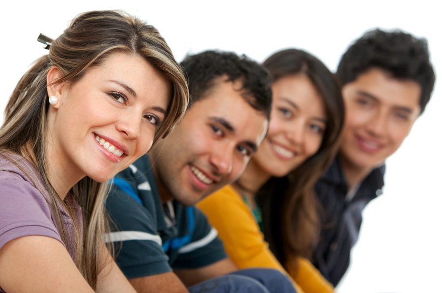 Happy group of young adults isolated over a white background