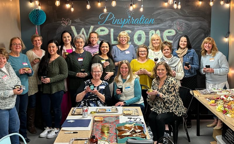 women posing together with candles