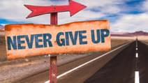Never Give Up sign with road background