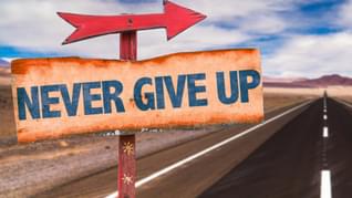 Never Give Up sign with road background