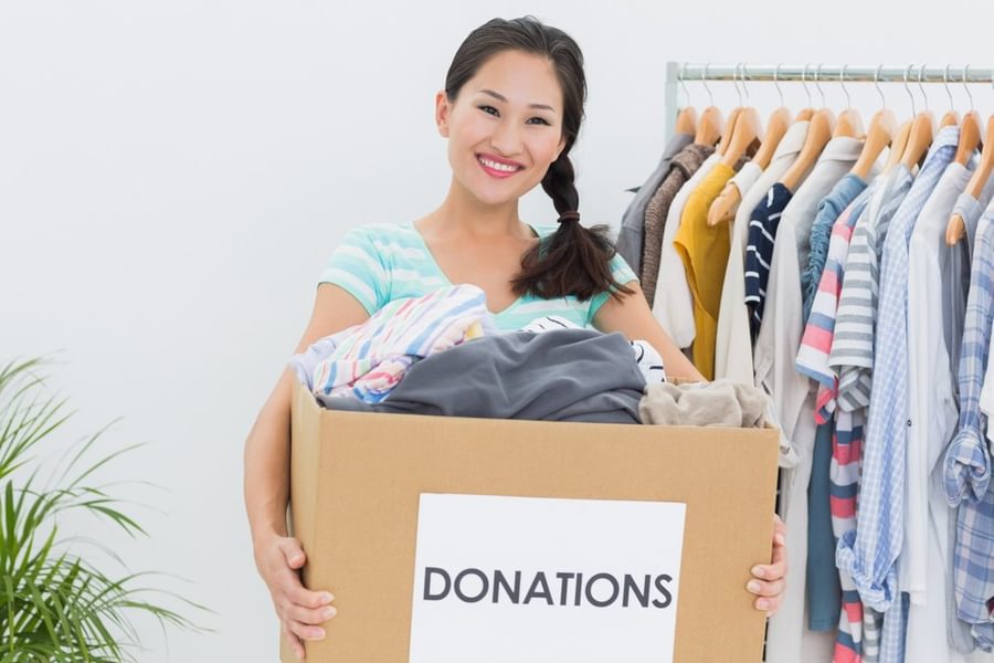 Portrait of a young woman with clothes donation