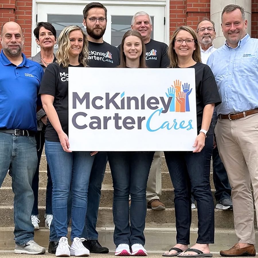 A group of employees holding a McKinley Carter Cares sign.