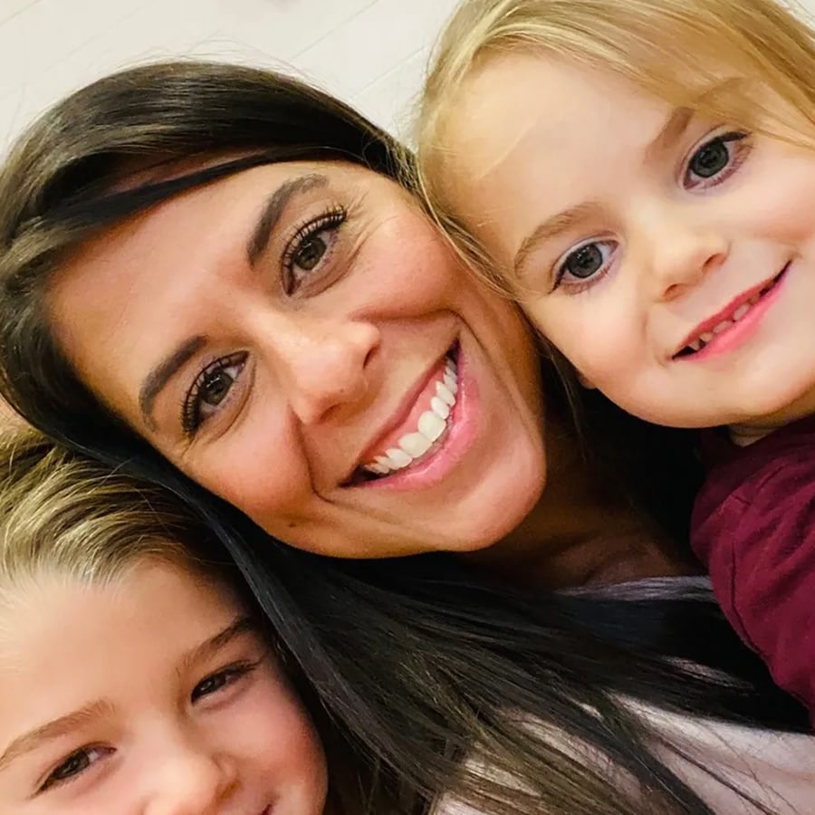 An employee smiling with children.