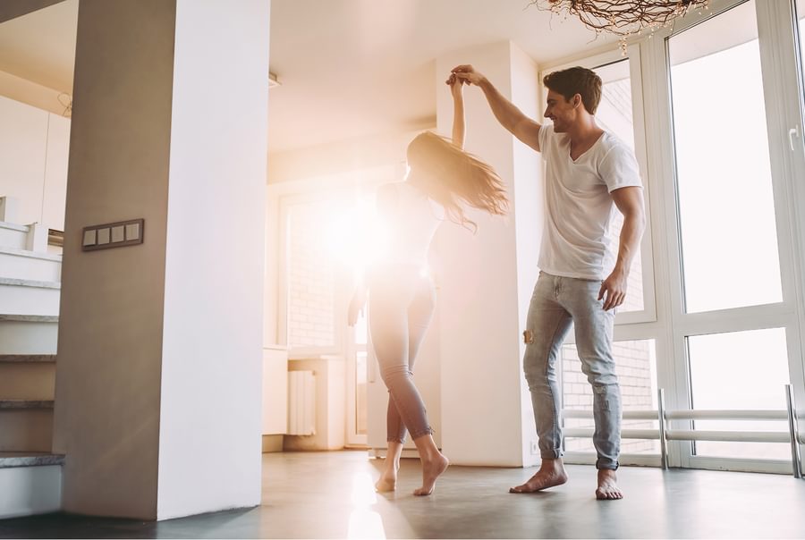 A couple dancing in their new home.