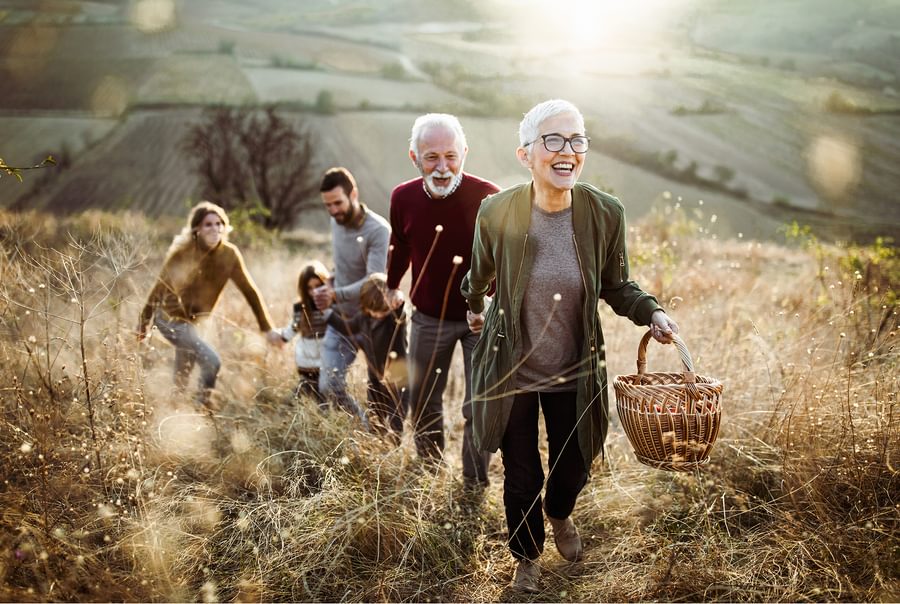 A. family walking up a hill enjoying their day.