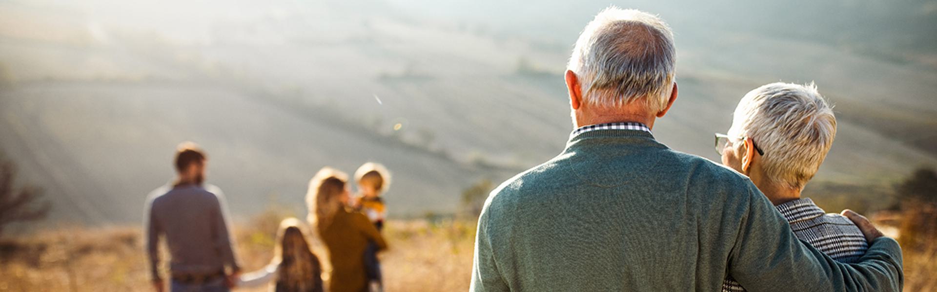 Grandparents looking at family.